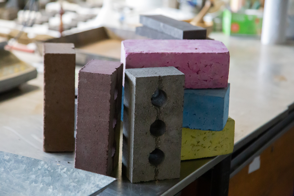 A novel brick is now offered that is made from waste materials