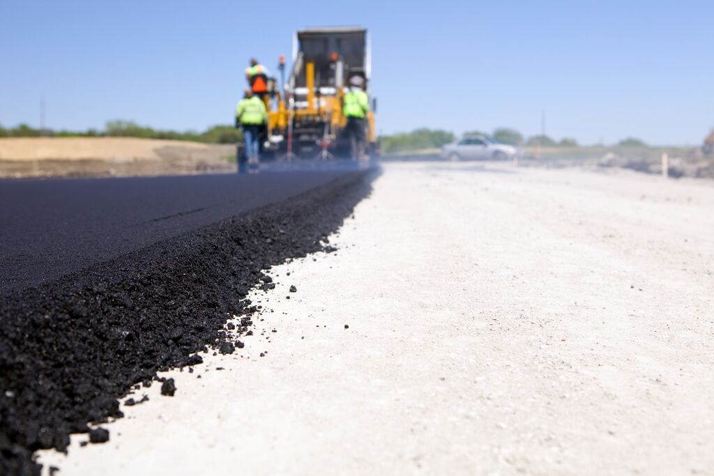 Blacktop Paving Road with Paver and Dump Truck | Photo: Shell