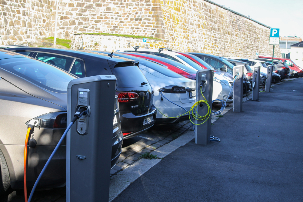 Electric cars plugged and charging at a car park in Oslo, Norway © Gvictoria | Dreamstime.com