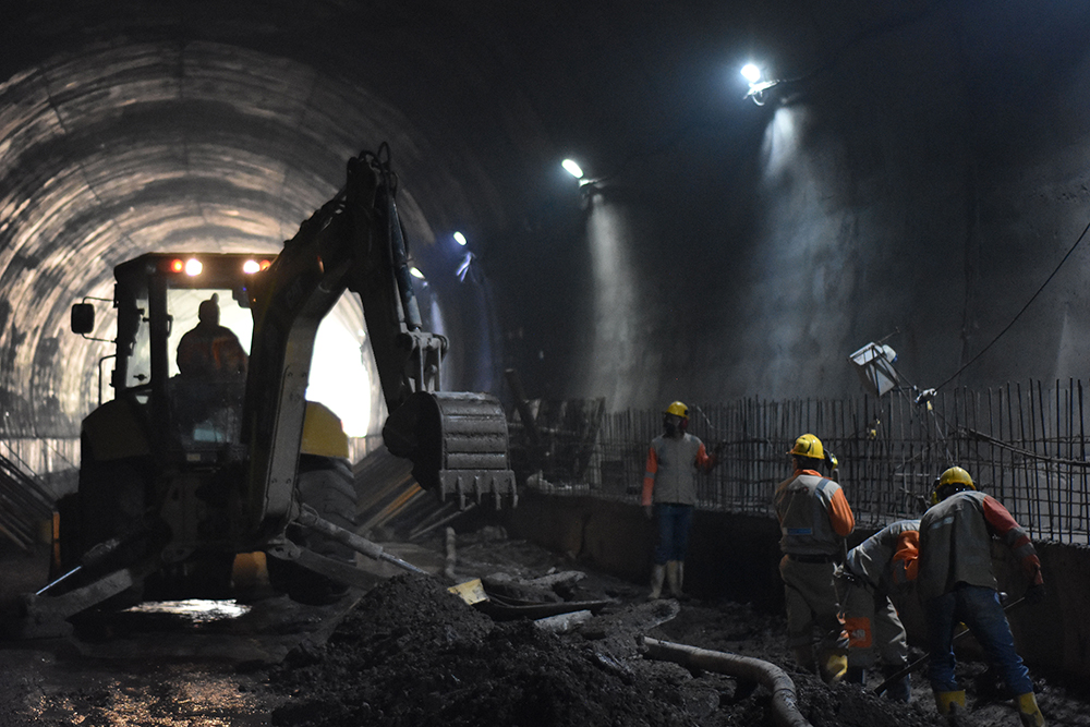 A backhoe loader has been used to prepare the  tunnel bed for paving - image courtesy of ANI 