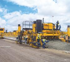 Concrete paving activity with a GOMACO machine has to fit in with climactic conditions at a job to refurbish Botswana's main airport.