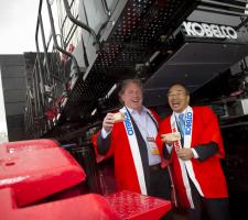 Herman Smit (Left) takes delivery of a new crane from Kobelco president and CEO Isao Aida