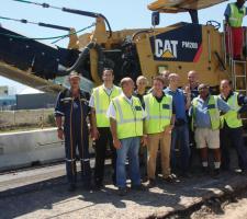 Vusela employees line up with the company's new Cat PM200 cold plane
