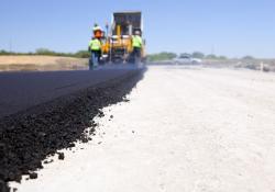 Blacktop Paving Road with Paver and Dump Truck | Photo: Shell